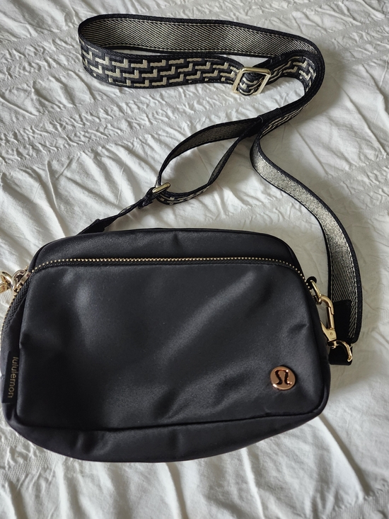 lululemon athletica Handbags - lululemon athletica Black Crossbody Bag with Gold Accents and Patterned Strap